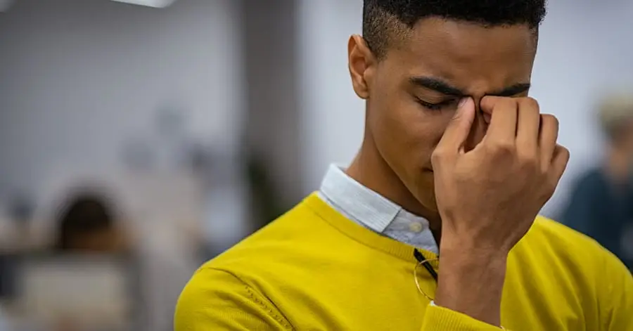 black man suffering from migraine
