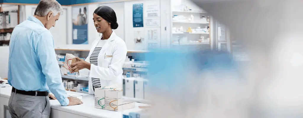 Pharmacists in pharmacy helping customers