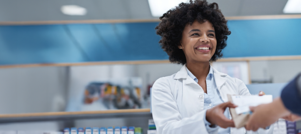 Pharmacist passing a prescription off to the customer