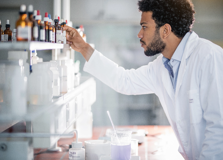 Pharmacist looking through pill bottles